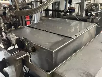 Top view of custom stainless steel replacement tank installed on a Nilfisk Delta Booster multi-pump pressure washer system.